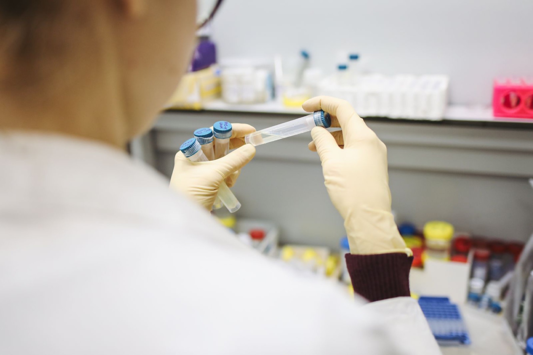 Technician handling sample vials in a pharmaceutical laboratory